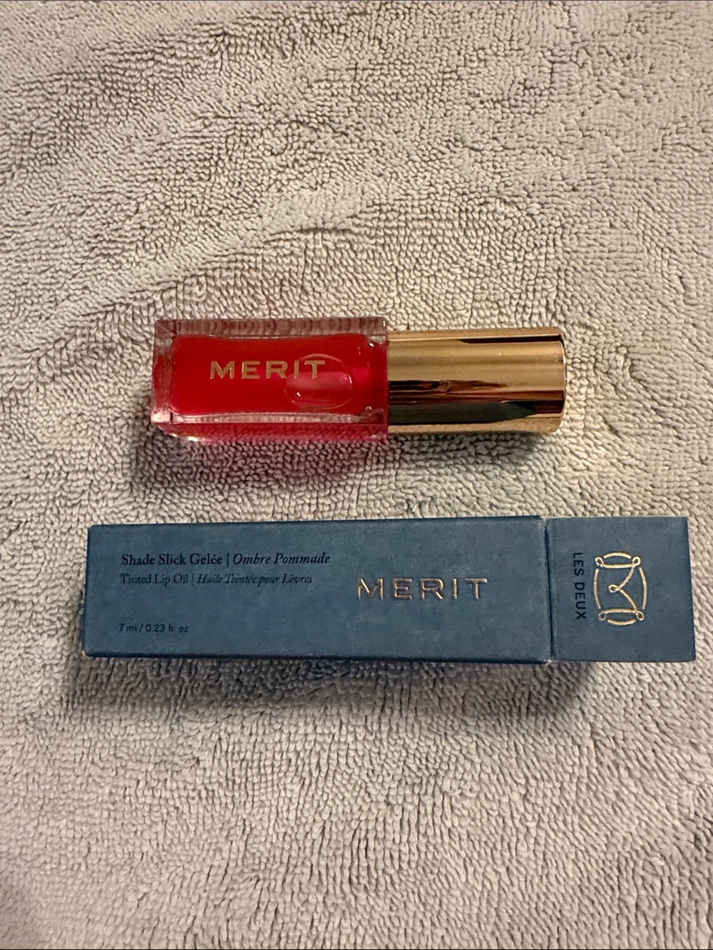 Merit Slick Gelée Tinted Lip Oil — color is Les Deux - clear pink/red. NEW
